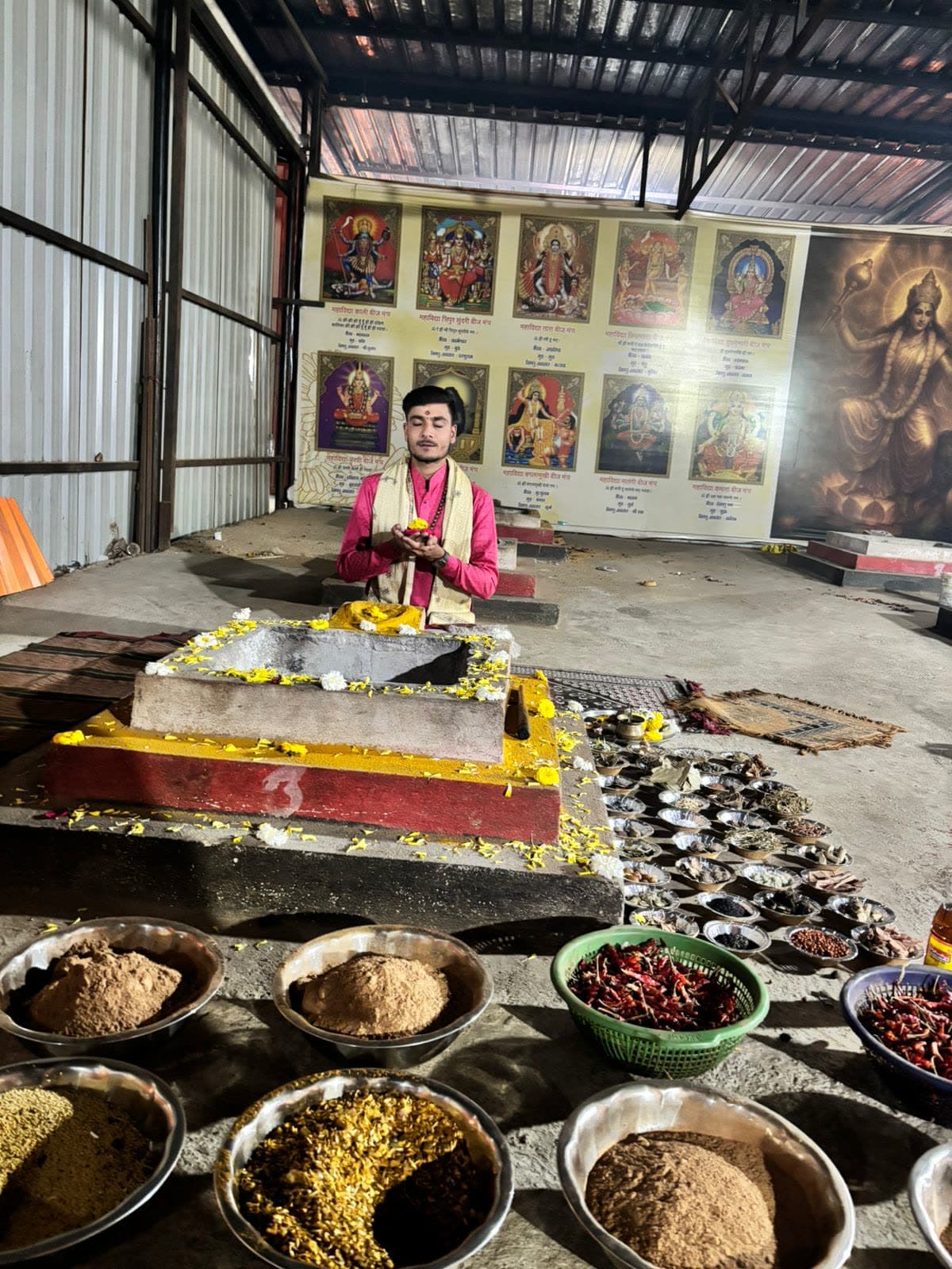 Aacharya Pandit Yogesh Sharma taking sankalp beside the hawan kund with puja samagri arranged