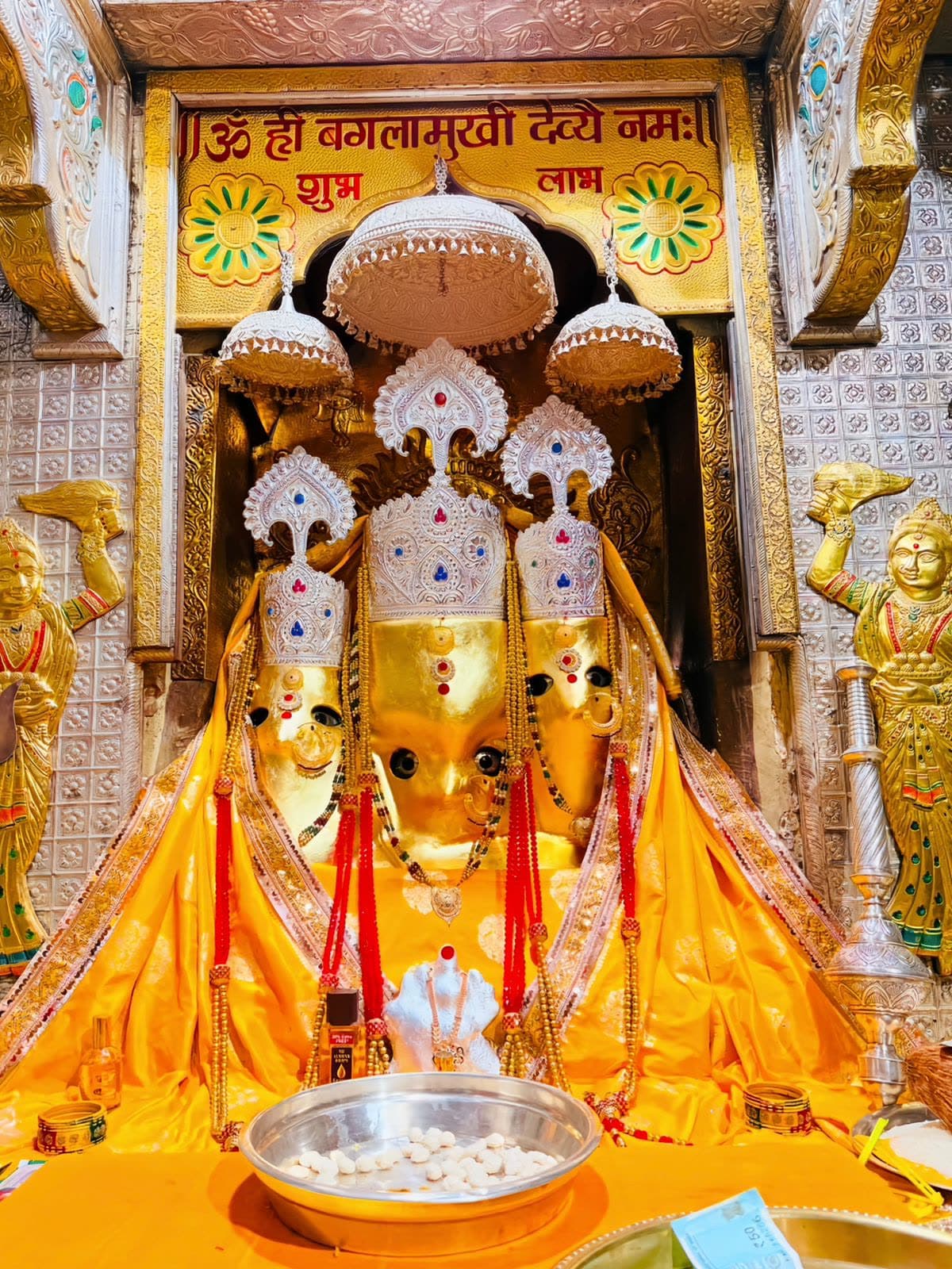 The garbhagriha of the Maa Baglamukhi Temple with the Devi adorned in gold