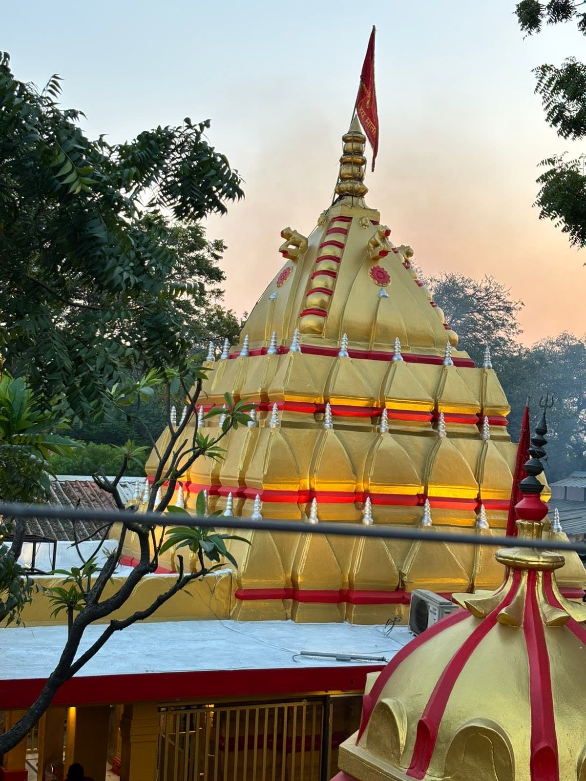 The golden shikhar of the Maa Baglamukhi Temple at Nalkheda at dusk